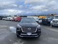 A 2017 Hyundai Santa Fe facing the camera with a sleek black exterior and prominent front grille