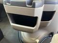 A beige cup holder unit designed for a 2012 Ford Econoline featuring two open compartments for holding cups or beverages