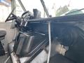 Interior view of a 2005 Freightliner MT45 Chassis showing the driver's seat dashboard and control panel with various instruments and storage compartments