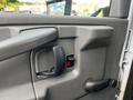 Interior view of a 2015 Chevrolet Express door panel featuring a handle and window controls