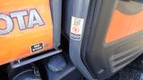 A 2013 Kubota RTV 1100 utility vehicle featuring an orange and black exterior with visible branding and operational instructions on the side