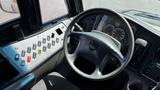 Interior view of a 2014 Freightliner Thomas Bus Diesel featuring a black steering wheel and control panel with various buttons and gauges