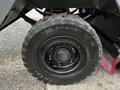 Close-up of a large black tire from a 2007 Tennant Sentinel showing tread pattern and wheel rim details