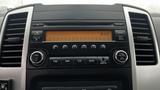 Dashboard of a 2016 Nissan Frontier featuring radio controls and a digital clock display