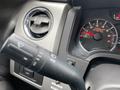 Close-up of the steering column controls and dashboard gauge of a 2014 Ford F-150 featuring the speedometer and an air vent