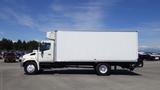 A white 2009 Hino 268 box truck with a large cargo area and a single cab, featuring a side view showcasing its length and simplicity