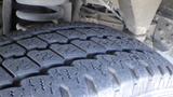 Close-up of a tire from a 2011 Ford Econoline showing detailed tread pattern and sidewall design