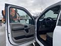 The interior of a 2017 Ford F-150 with an open driver's door showcasing the dashboard and seats