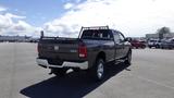 2014 RAM 3500 pickup truck viewed from the rear showing its chrome accents and bed rack with 4x4 emblem on the tailgate