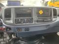 Dashboard of a 2008 Hino Conventional Cab featuring a stereo system climate controls and various switches and knobs
