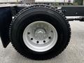 Close-up of a Michelin tire mounted on a silver wheel of a 2014 Kenworth T370 truck