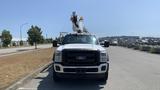 2011 Ford F-450 SD truck with a mounted aerial lift on the bed facing forward