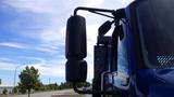 A 2012 International DuraStar 4300 truck featuring a side mirror and a glossy blue exterior