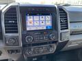Dashboard of a 2019 Ford F-350 SD showing a touchscreen display with various control buttons for audio navigation and climate settings
