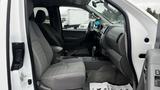 Interior view of a 2016 Nissan Frontier showing the driver's side with gray upholstery and a central console