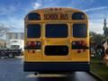 A 2005 Blue Bird school bus with a yellow exterior and large "SCHOOL BUS" lettering on the back