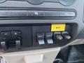 Dashboard controls of a 2009 Ford F-450 SD featuring auxiliary switches labeled AUX 1 AUX 2 AUX 3 AUX 4 and a button marked ROTO