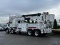 A 2011 Western Star Trucks 4900 with an elevated bucket and utility equipment mounted on the rear visible in side profile