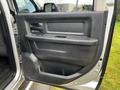 Interior view of a 2012 RAM 3500 driver's side door with door handle window controls and storage compartment