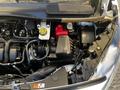 Close-up of the engine compartment of a 2022 Ford Transit Connect showing the engine components and battery